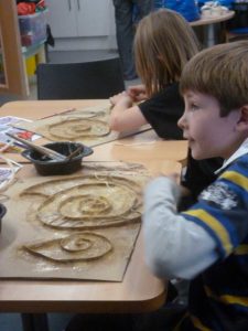 Children enjoy making fossil art at the Artz+ event in Bridport